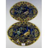 Two bullion and silk embroidered ornamental oval mats, each of cobalt blue silk, decorated with