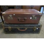 A brown suitcase together with another in blue