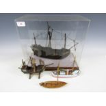 A cased model galleon together with three small wooden ships