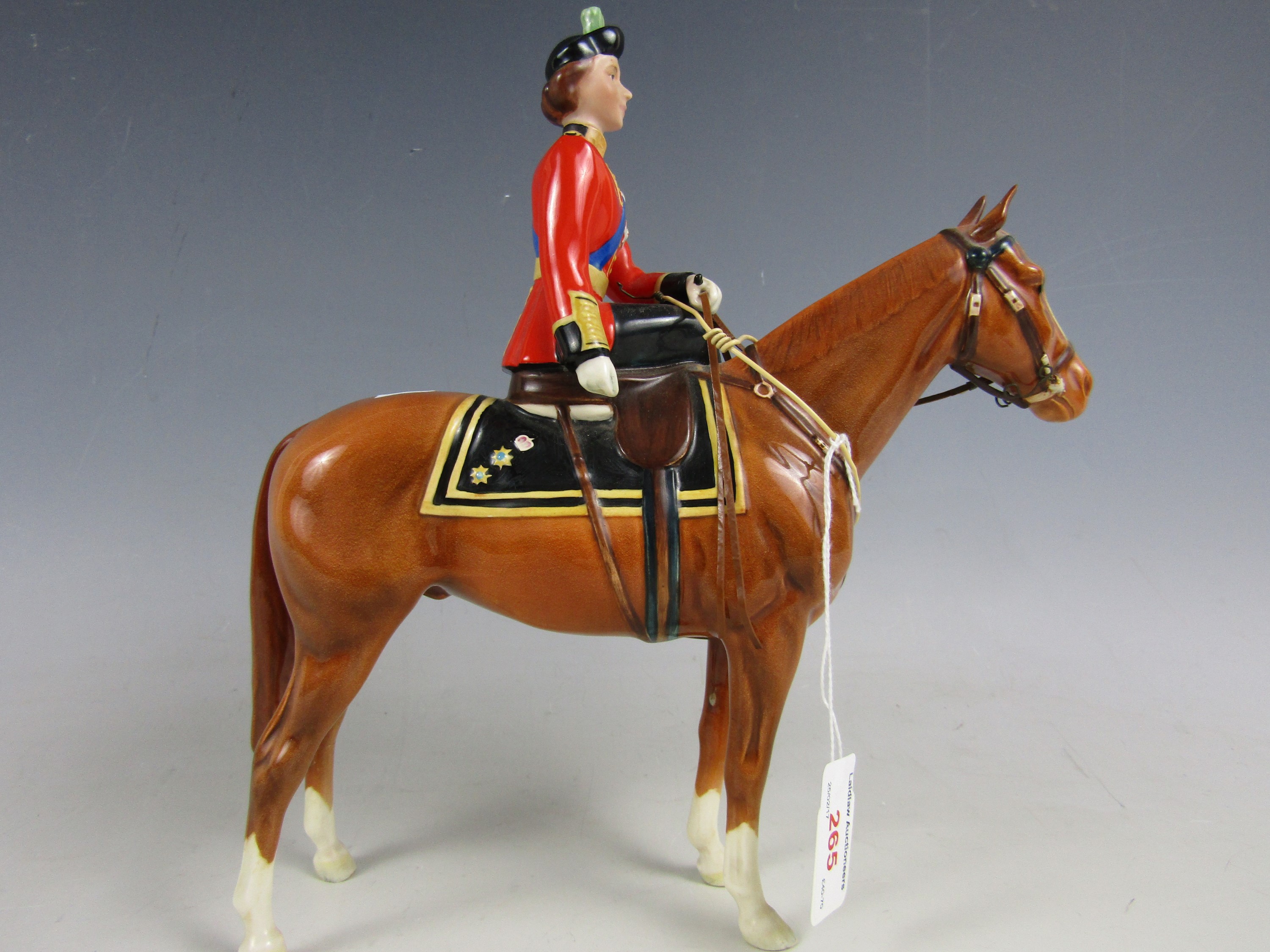 A Beswick figurine depicting Her Majesty Queen Elizabeth II mounted on Imperial, trooping the