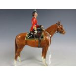 A Beswick figurine depicting Her Majesty Queen Elizabeth II mounted on Imperial, trooping the
