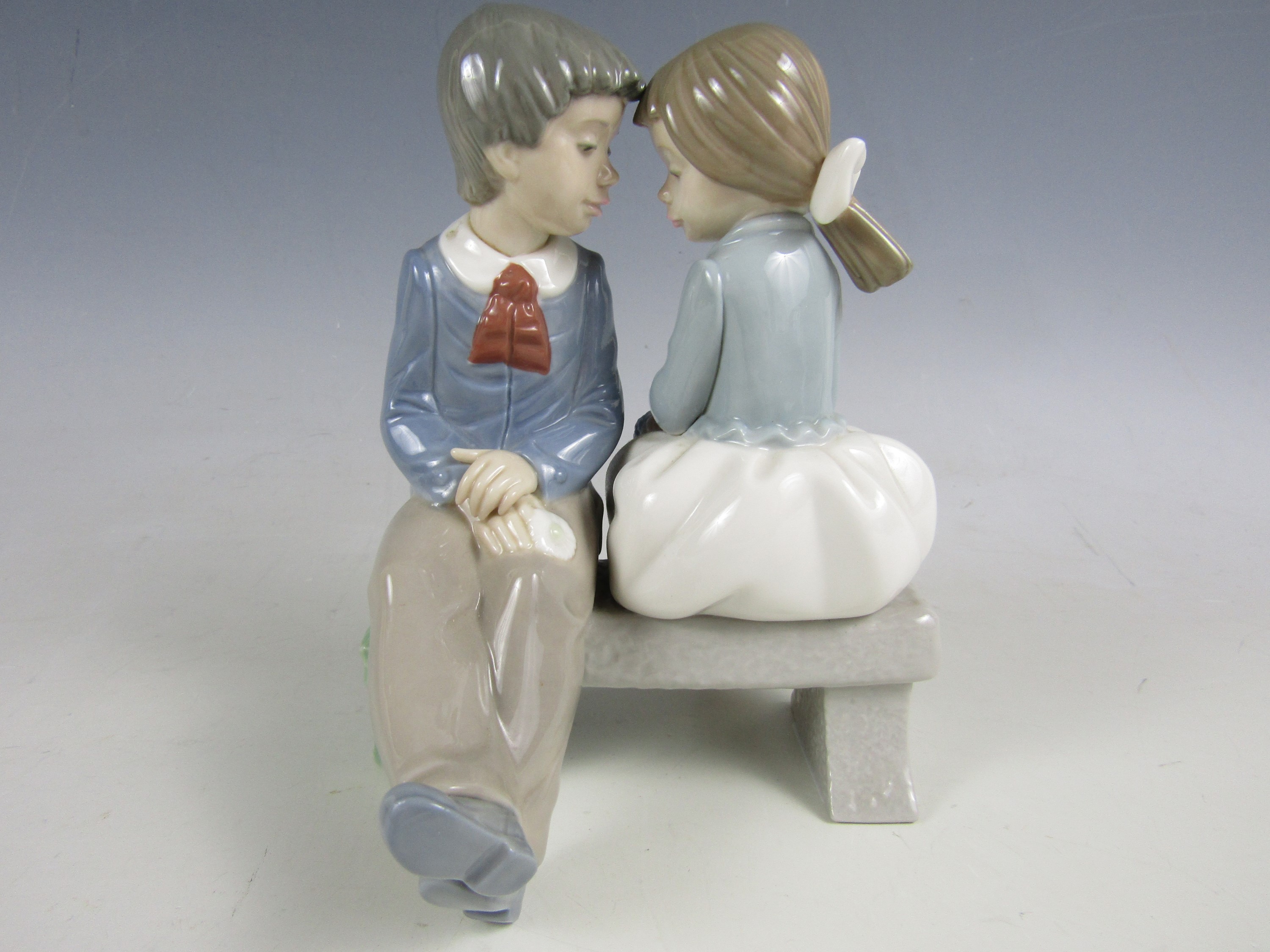 A Nao figurine of a boy and girl