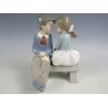 A Nao figurine of a boy and girl