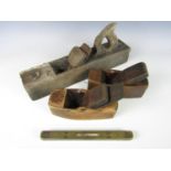 Three wooden block planes together with a Mathieson brass spirit level