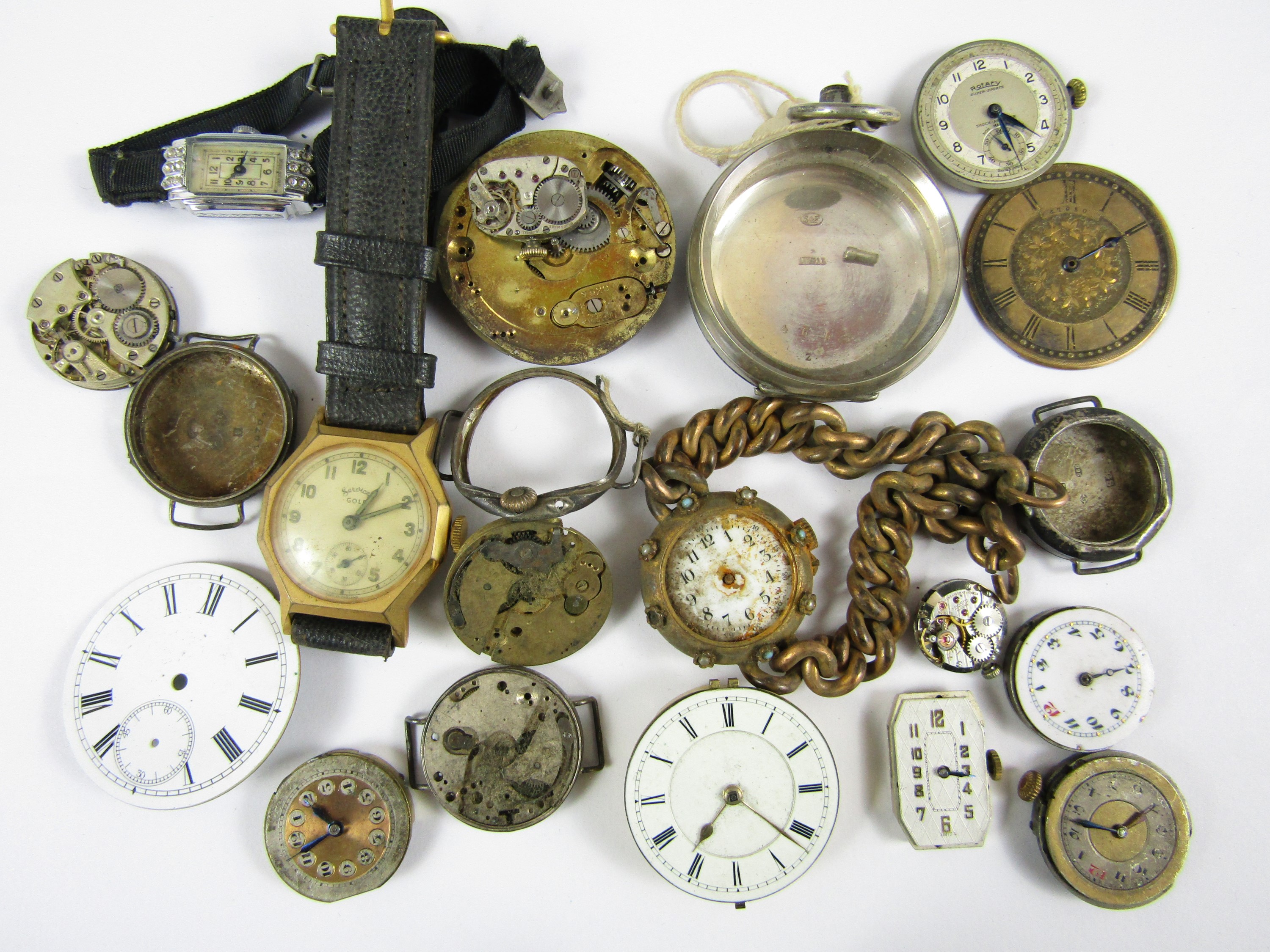 A quantity of vintage watch movements and silver watch cases