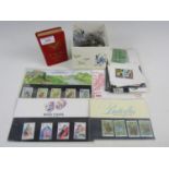 A quantity of coins, first day covers, a book money box and contents