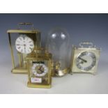 Three contemporary clocks together with a domed clock case