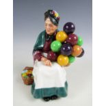 A Royal Doulton balloon seller figurine