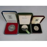 Two Royal Mint silver proof crowns together with a proof 50 pence coin