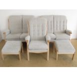 A five piece suite in light beech comprising two two-seater sofas, two footstools and an armchair,