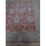A large coral and pale gold oriental rug, 280 x 188 cm