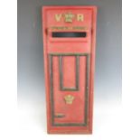 A reproduction cast iron post box front