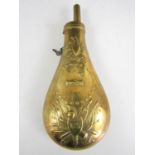 A brass reproduction US Army powder flask