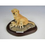 A boxed Border Fine Arts figurine of a golden retriever with pups