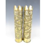 A pair of Trench Art vases with leaf decoration