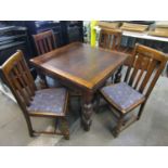 An oak draw leaf table and four dining chairs