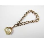 A yellow-metal and citrine swivel fob seal, stamped 9ct, on a gilt metal curb link chain with