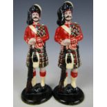 Two early 20th Century enamelled die cast metal figures of Highland soldiers, 18 cm