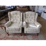 A pair of contemporary beige upholstered armchairs