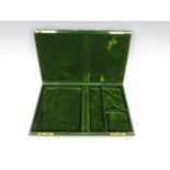 A vintage jewellery box with green velvet lined interior