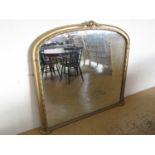 A large reproduction Victorian gilt framed over mantle mirror