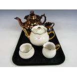 A three piece Arthur Wood tea set, a Victorian lustre tea pot and a jug