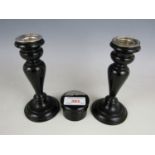 A pair of ebony and silver mounted candlesticks together with a silver mounted trinket pot