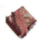 A 19th Century printed paisley shawl, with curved and tasselled lower edge, 330 x 180 cm