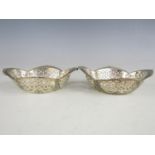 A pair of Edwardian silver bon-bon dishes, each of quatrefoil section, with reticulated and