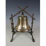 A late 19th / early 20th Century electroplate dinner bell, mounted within a simulated wood frame