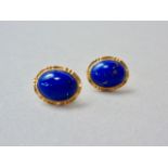 A pair of lapis lazuli cabochon and yellow metal stud earrings