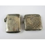 Two silver vesta cases, one densely engraved in a canted geometric and foliate design, surrounding a