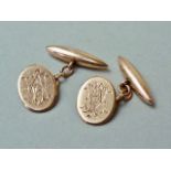 An Edwardian gentleman's pair of 9ct rose gold cuff links, the chamfered oval face engraved with a