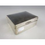 An Edwardian silver table cigarette box, with subtly domed cover engraved with a cursive initial '