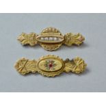 Two Victorian Etruscan Revival yellow metal bar brooches set with paste stones, each marked 9ct,