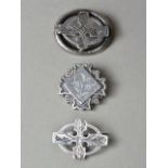 Three Victorian engraved white metal brooches, each incorporating a cruciform device, test as