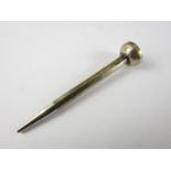 A vintage novelty propelling pencil in the form of a golf tee, marked sterling silver, tests as