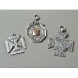 Two Victorian silver fob medallions, one with engraved 'SB', Chester 1868, the other of cruciform