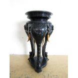 A late 19th / early 20th Century Anglo-Indian ebonised jardinière stand, modelled as three