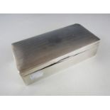 A George V silver table cigarette box, of rounded rectangular form, the cover having engine-tuned