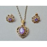 A matched suite of vintage jewellery, comprising pendant necklace and earrings, the former in the