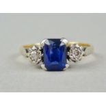 An early 20th Century diamond and blue stone doublet dress ring, with central scissor-cut stone