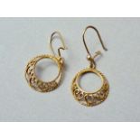 A pair of 9ct gold pendant earrings, each in the form of offset annuli connected by filigree C