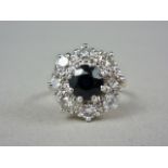 A sapphire and diamond flower head cluster dress ring, the round cut sapphire of approximately 1ct