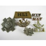 A group of Scottish military insignia comprising a 5th Royal Scots cap or accoutrements badge,