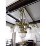 An early 20th Century gilt brass and glass chandelier, comprising a central glass shade with four