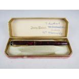 A 1950s Conway Stewart No.759 fountain pen in burgundy marble with 14K gold nib, in original box