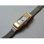 A 1920s lady's Art Deco influenced 18ct gold cased wristlet watch, having a Swiss made 15-jewel