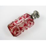 A Victorian white-metal mounted and ruby flashed cut glass scent bottle, with hinged cover and