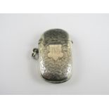 An Edwardian silver vesta case, of oval shape, the covers densely engraved with foliage